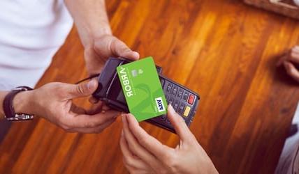 Member using Arbor's tap to pay debit card at store